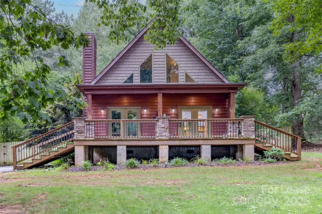 a view of a house with a yard balcony and sitting area