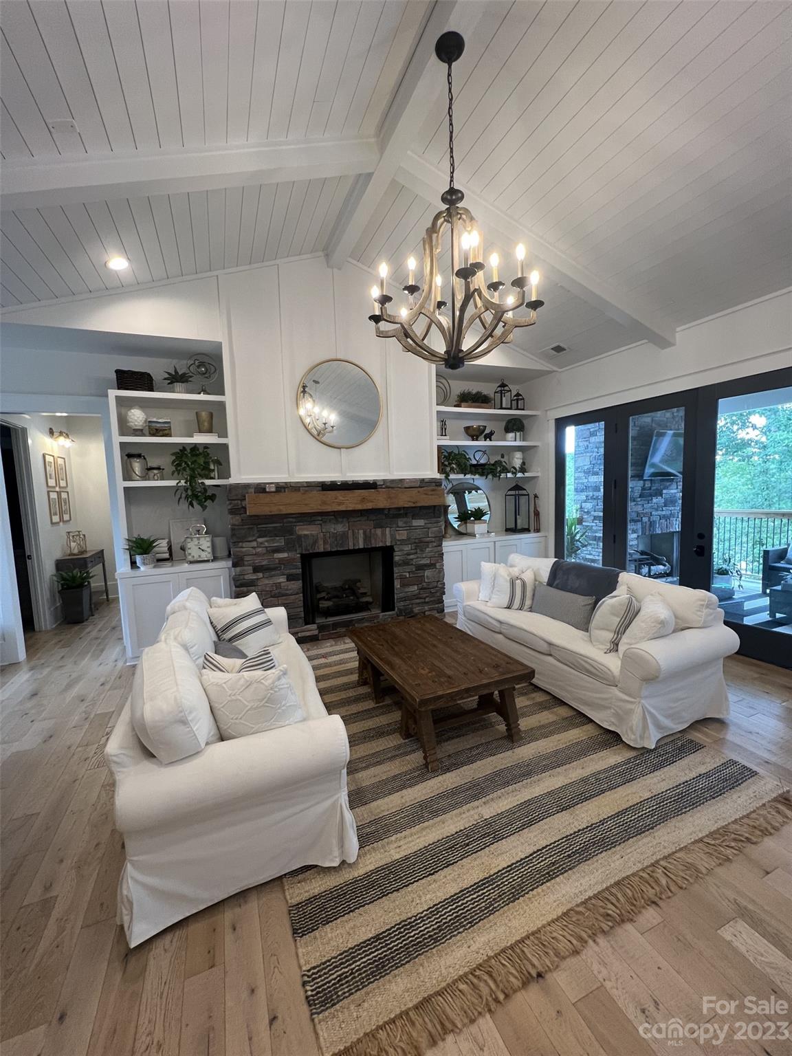370 Calming Way Tega Cay, SC 29708 - Photo 7 of 24 a living room with furniture a fireplace and a chandelier