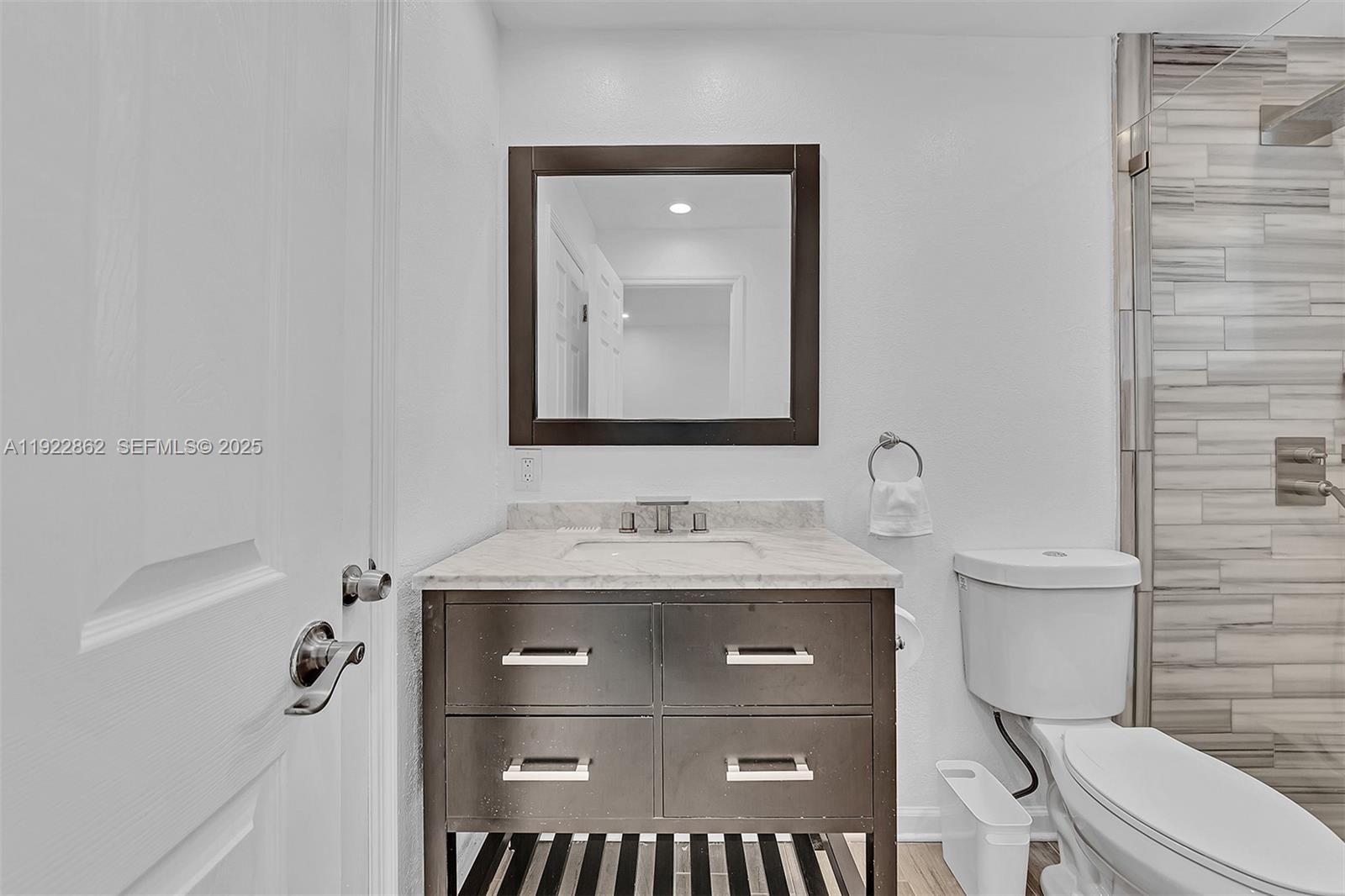 1960 Riverside Drive Fort Lauderdale, FL 33312 - Photo 21 of 89 a bathroom with a granite countertop toilet sink and mirror