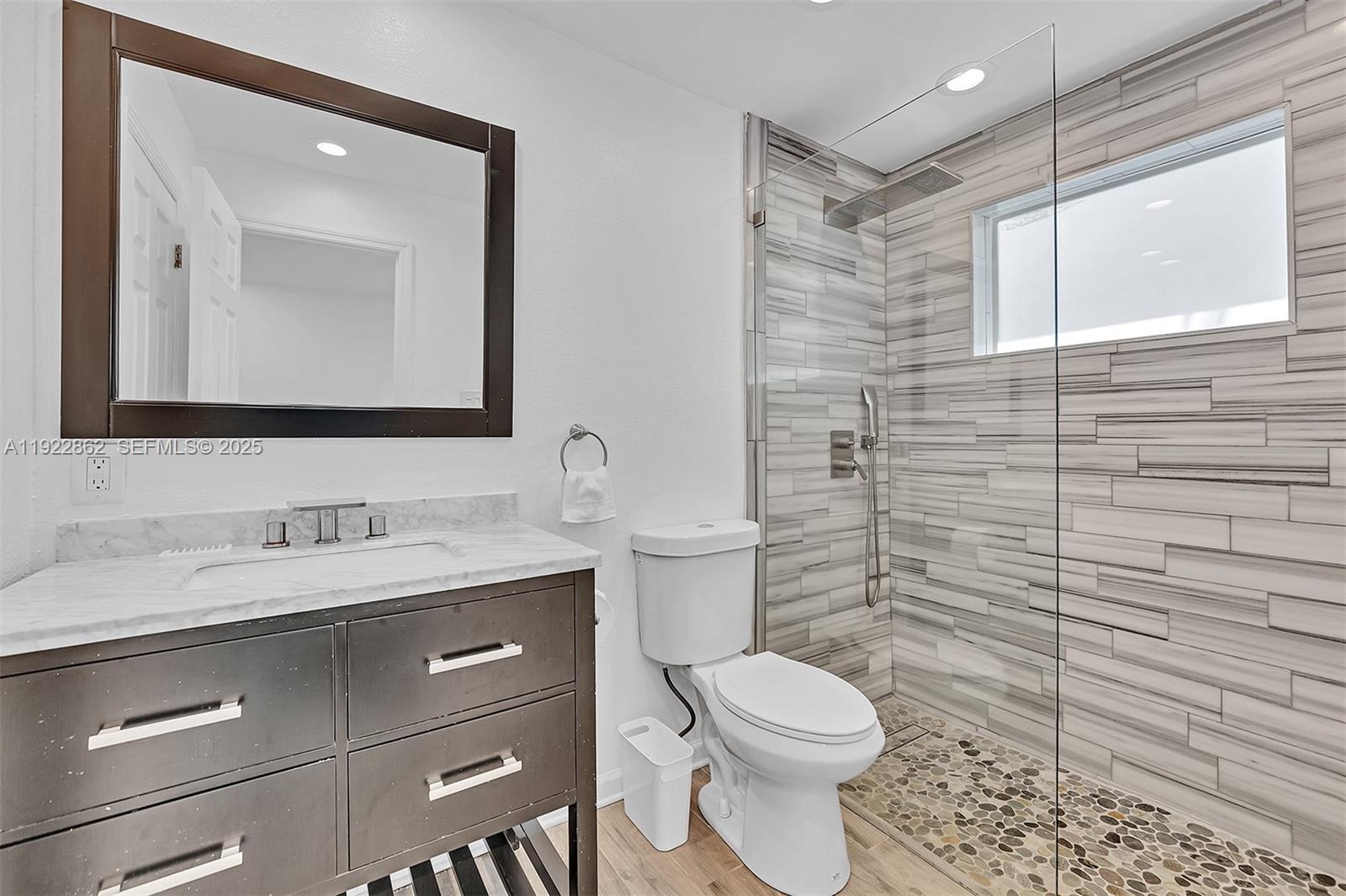 1960 Riverside Drive Fort Lauderdale, FL 33312 - Photo 22 of 89 a bathroom with a granite countertop toilet sink and mirror