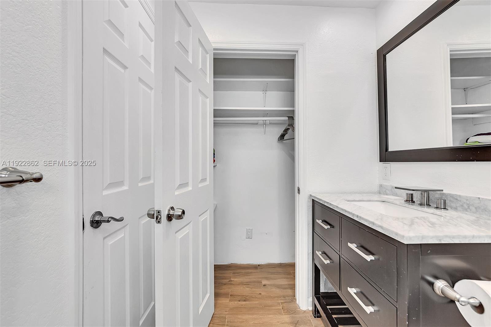 1960 Riverside Drive Fort Lauderdale, FL 33312 - Photo 24 of 89 a bathroom with a sink vanity and a mirror