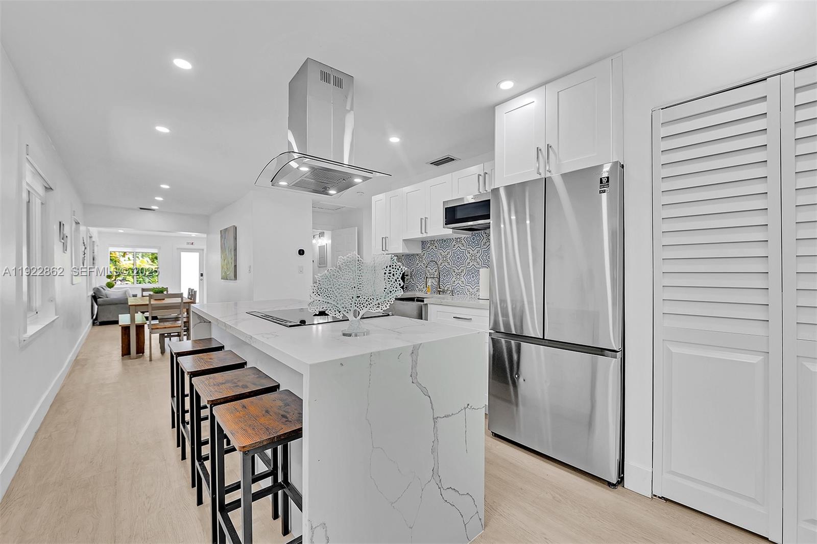 1960 Riverside Drive Fort Lauderdale, FL 33312 - Photo 28 of 89 a kitchen with stainless steel appliances a refrigerator a sink dishwasher and a stove with wooden floor
