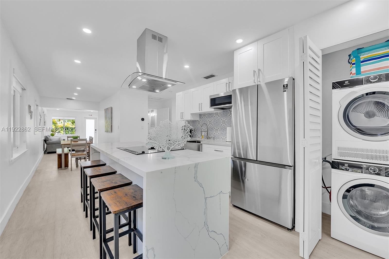 1960 Riverside Drive Fort Lauderdale, FL 33312 - Photo 29 of 89 a kitchen with stainless steel appliances a stove a refrigerator and a refrigerator with wooden floor