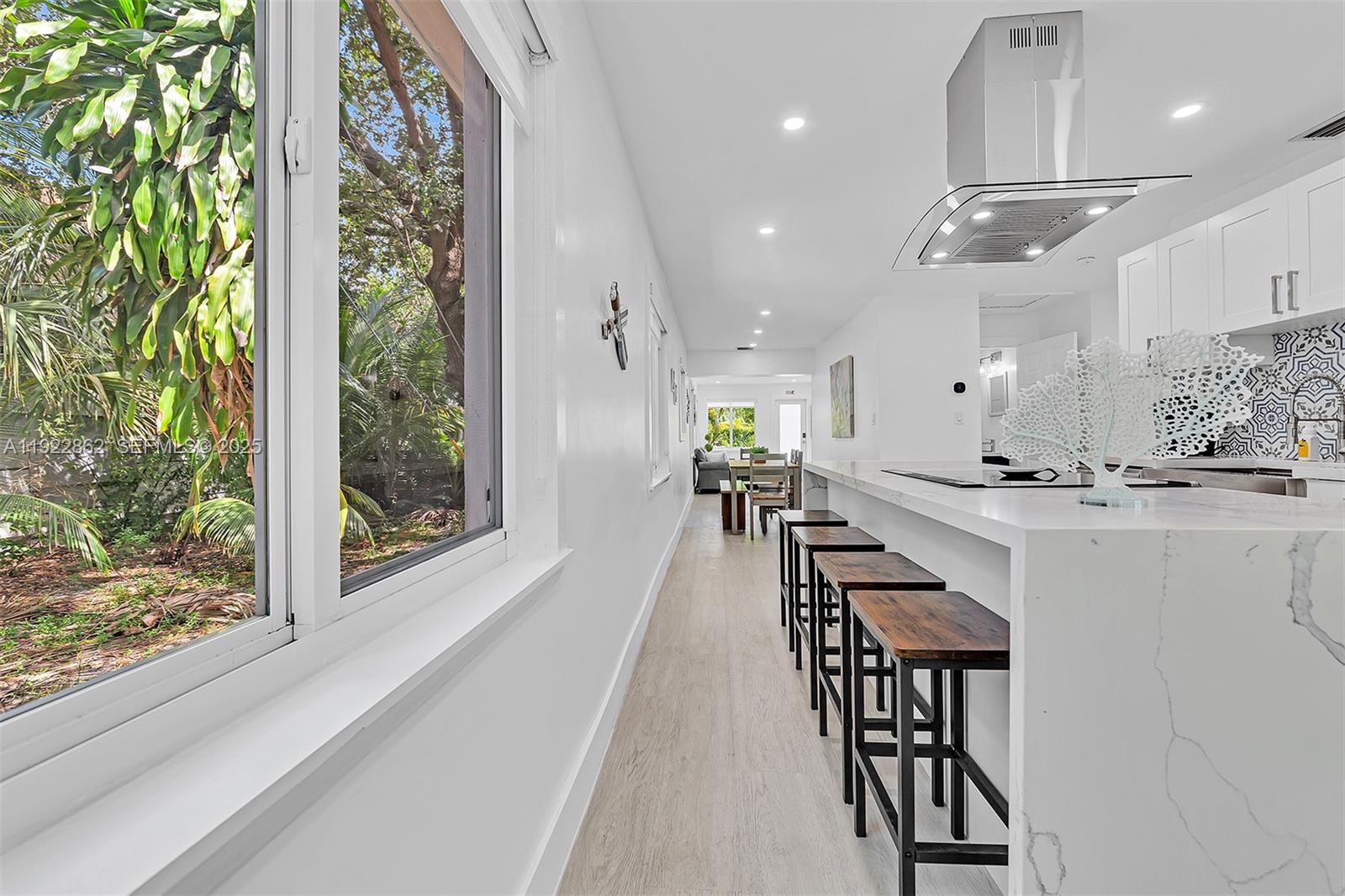 1960 Riverside Drive Fort Lauderdale, FL 33312 - Photo 31 of 89 a view of a kitchen with kitchen island stainless steel appliances wooden floor dining table and chairs