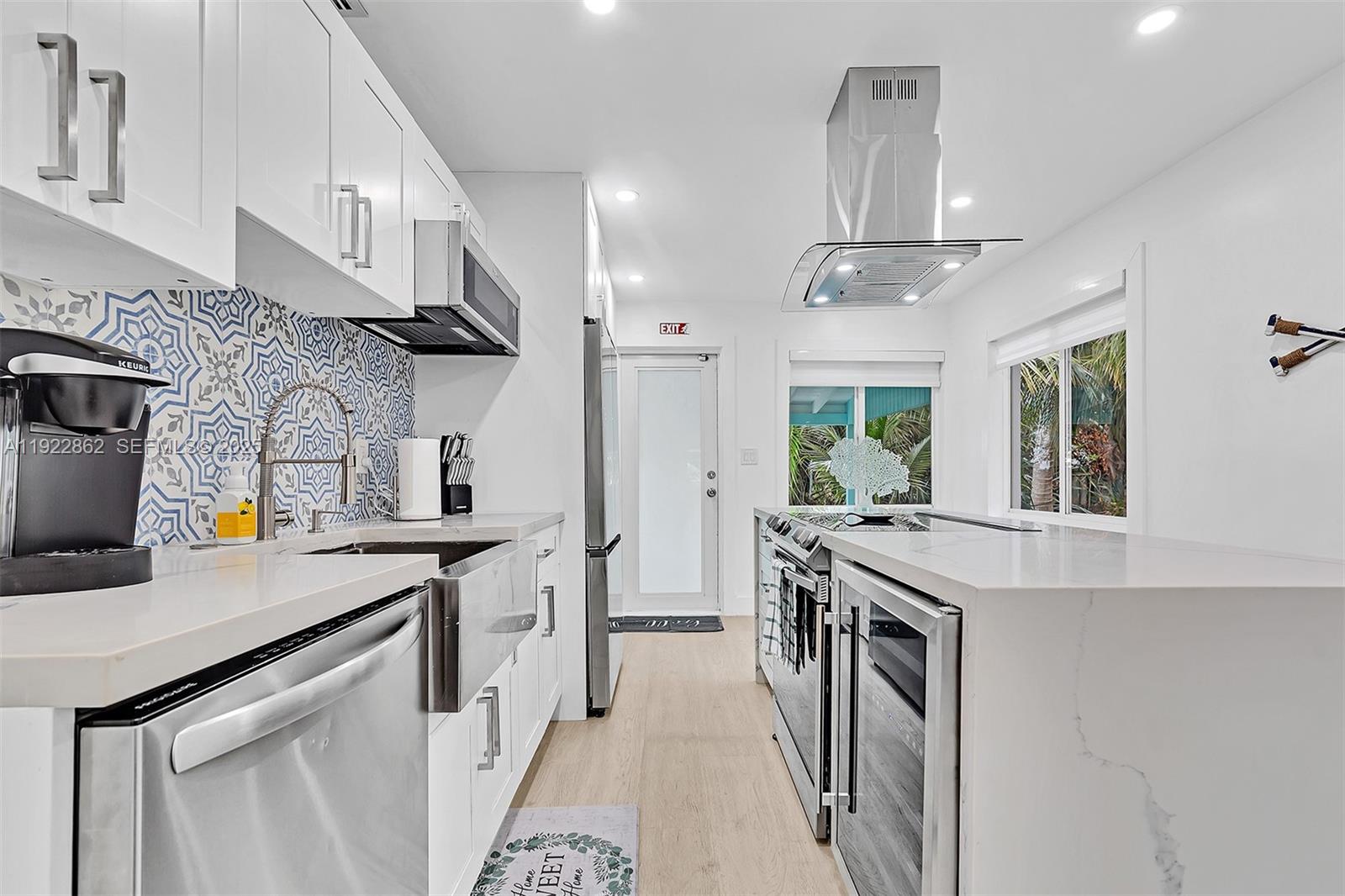 1960 Riverside Drive Fort Lauderdale, FL 33312 - Photo 34 of 89 a kitchen with stainless steel appliances a sink stove and cabinets
