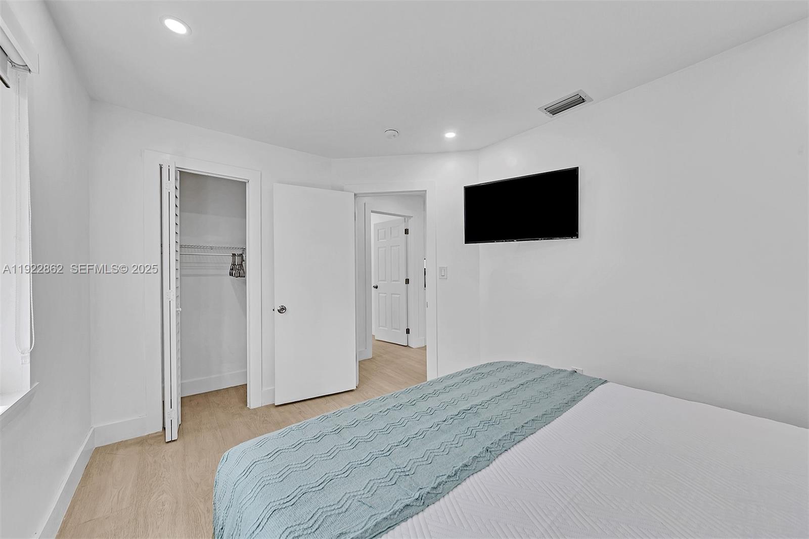 1960 Riverside Drive Fort Lauderdale, FL 33312 - Photo 44 of 89 a bedroom with a bed and a flat screen tv