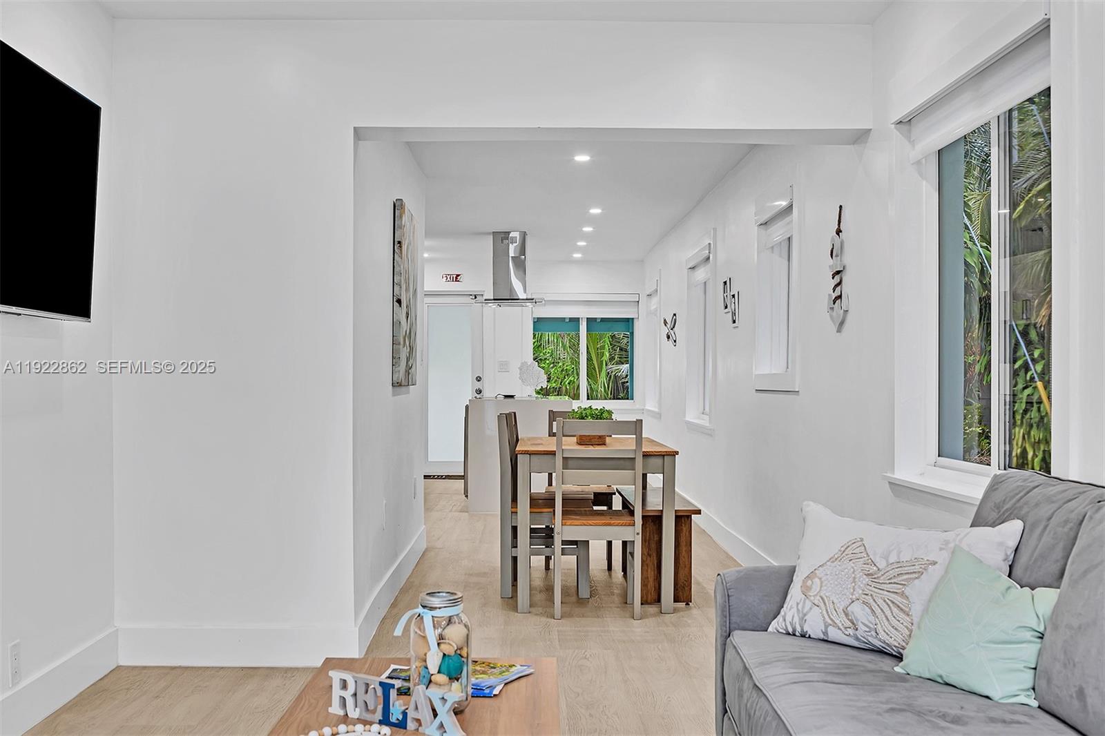 1960 Riverside Drive Fort Lauderdale, FL 33312 - Photo 50 of 89 a living room with furniture a flat screen tv and a window