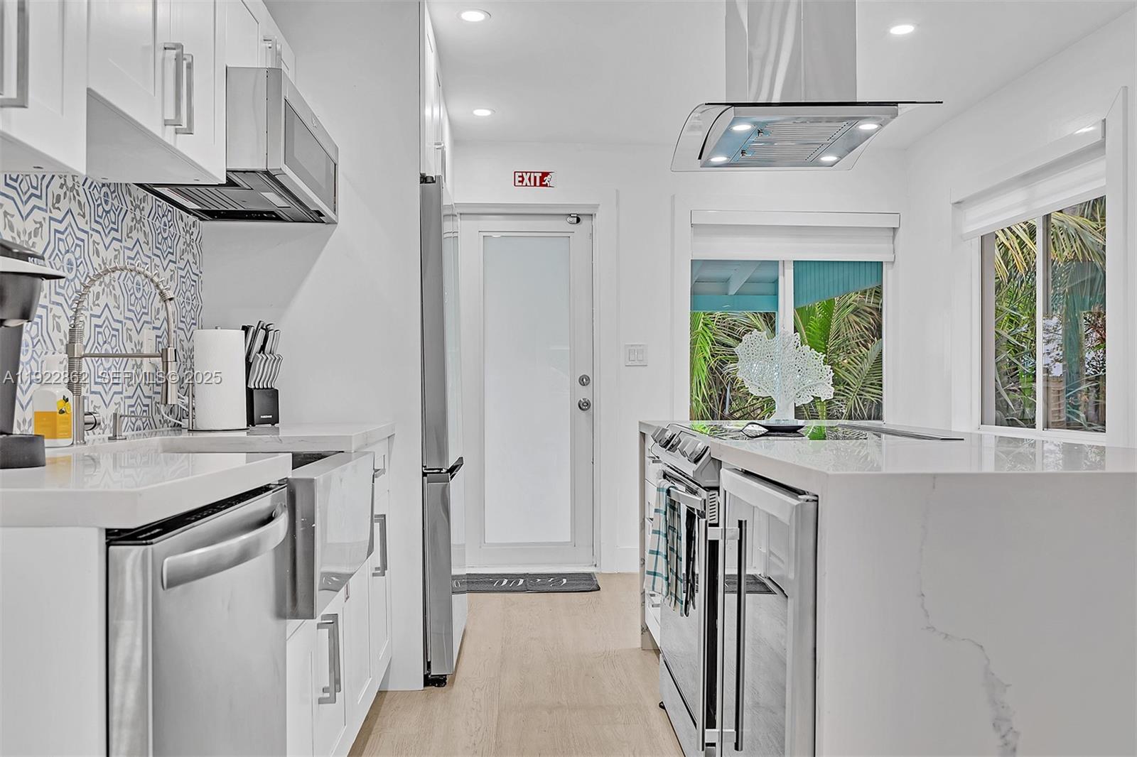 1960 Riverside Drive Fort Lauderdale, FL 33312 - Photo 54 of 89 a kitchen with stainless steel appliances granite countertop a sink a stove and a refrigerator