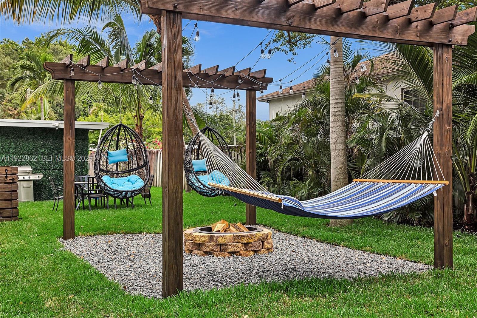 1960 Riverside Drive Fort Lauderdale, FL 33312 - Photo 6 of 89 a view of a chair and table in backyard of the house
