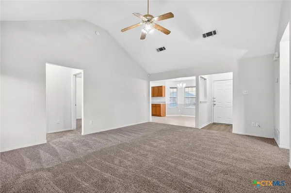 a view of empty room with ceiling fan