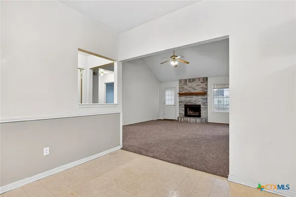 a view of an empty room with a fireplace