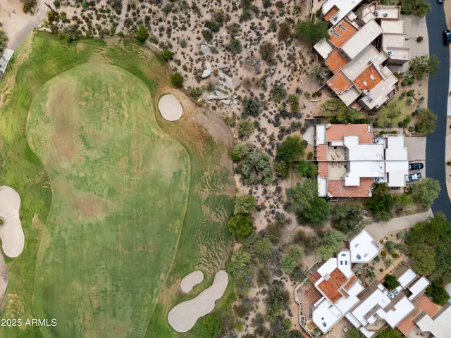 an aerial view of a house with a yard