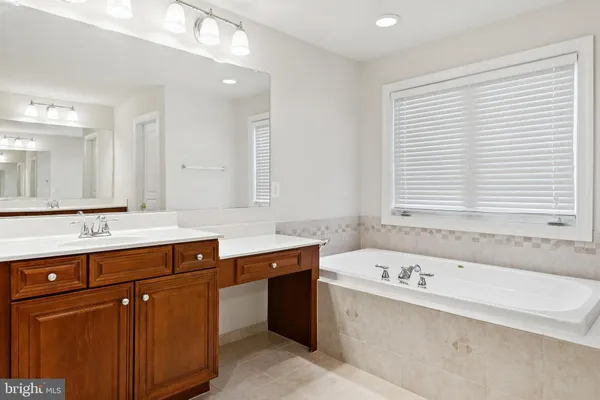 a bathroom with a granite countertop sink mirror and double