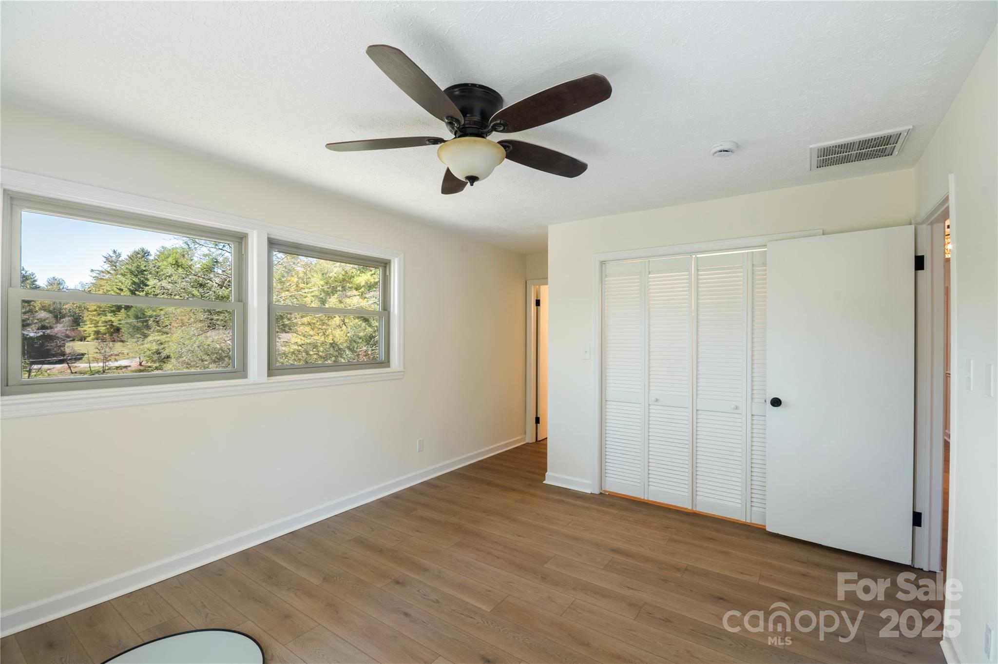 90 Joe Jenkins Road Fairview, NC 28730 - Photo 21 of 46 a view of empty room with wooden floor and window