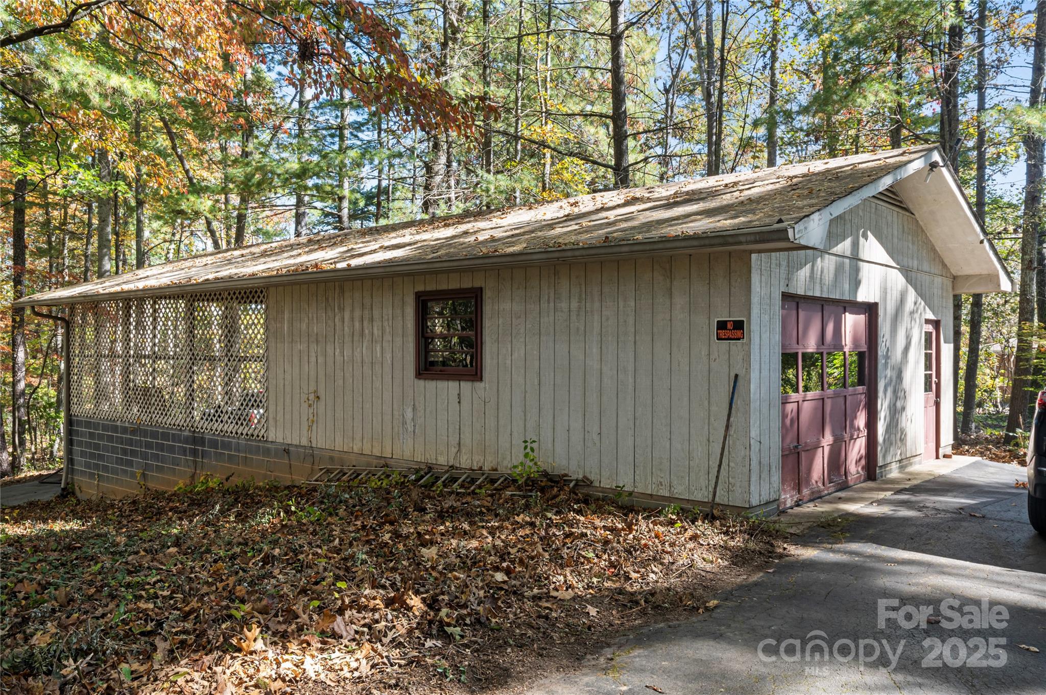 90 Joe Jenkins Road Fairview, NC 28730 - Photo 41 of 46 a backyard of a house with large trees and wooden fence