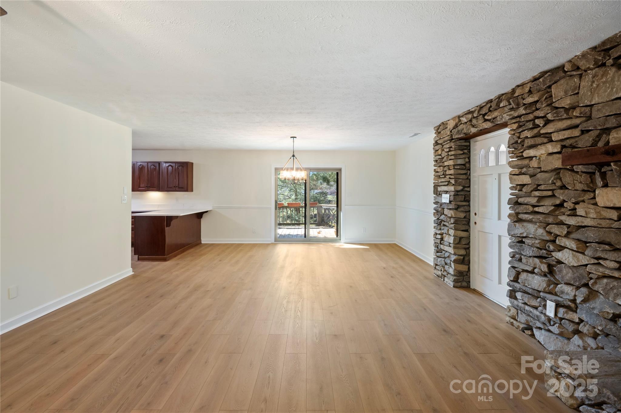 90 Joe Jenkins Road Fairview, NC 28730 - Photo 10 of 46 an empty room with wooden floor and windows