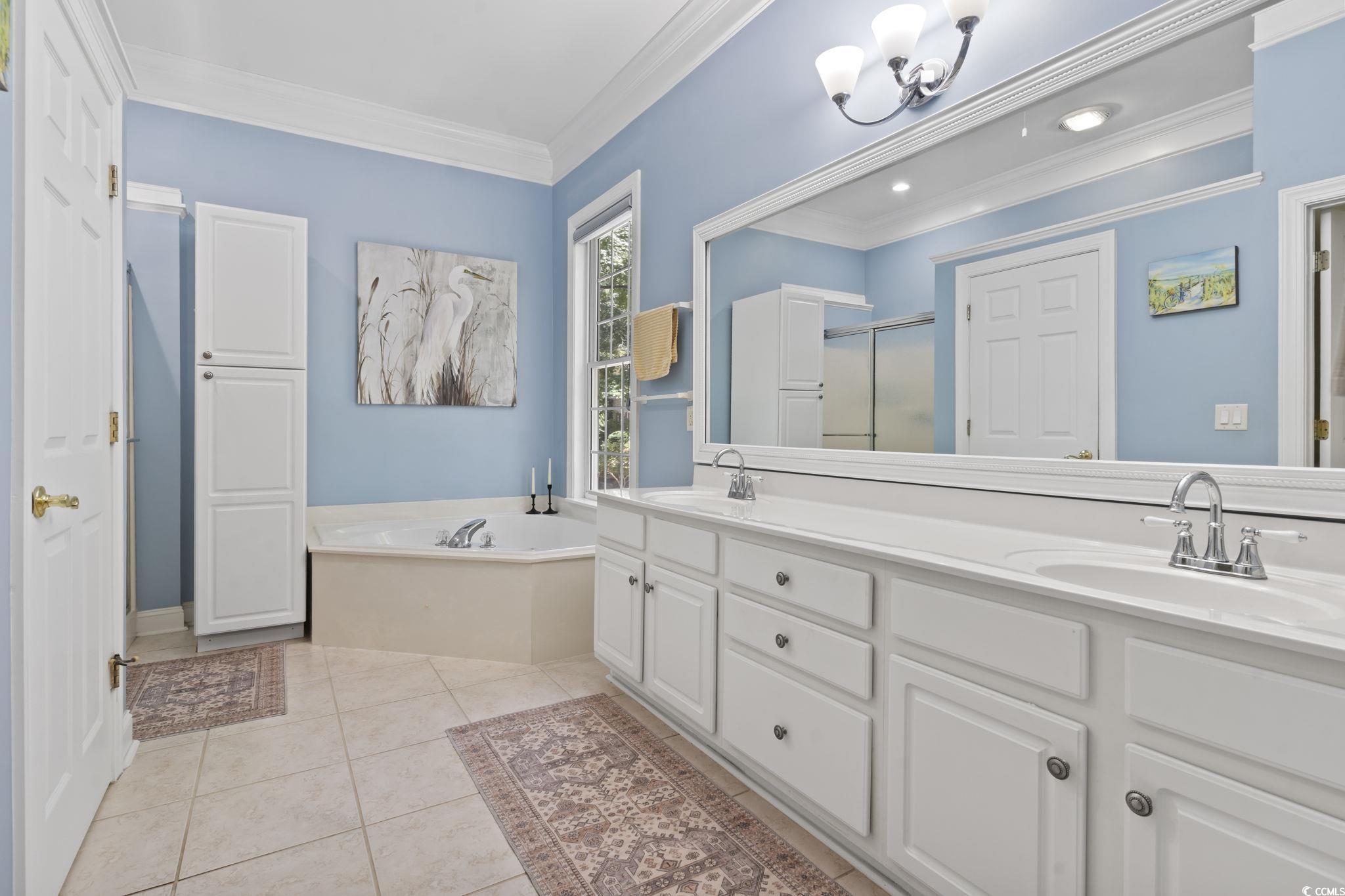 4495 Trotters Court Murrells Inlet, SC 29576 - Photo 11 of 29 Full bathroom with a garden tub, double vanity, crown molding, a stall shower, and tile patterned flooring