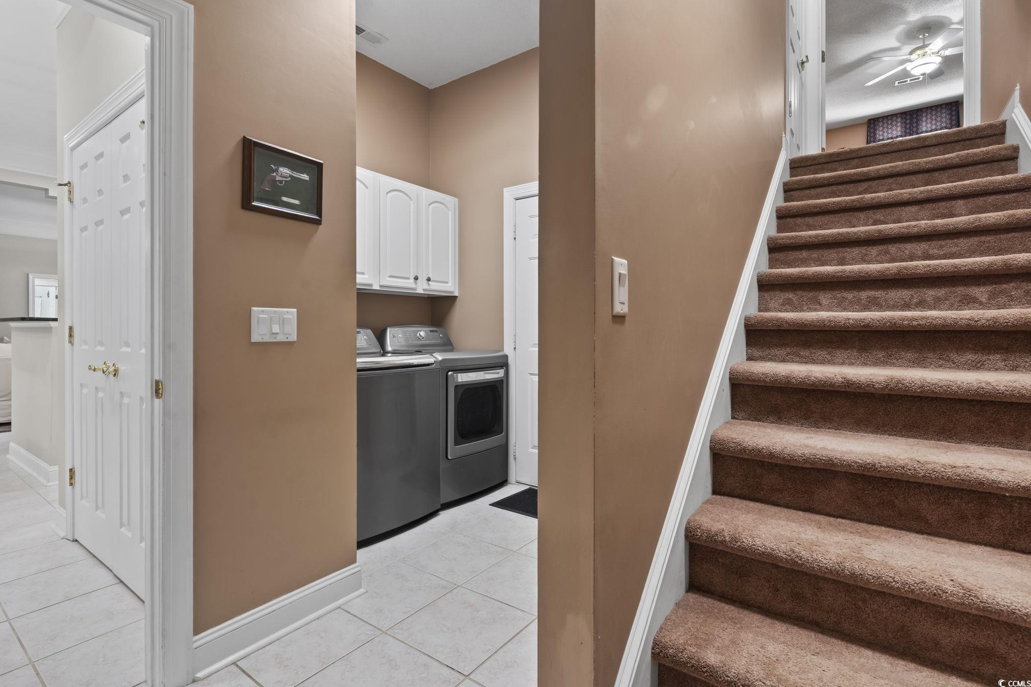 4495 Trotters Court Murrells Inlet, SC 29576 - Photo 12 of 29 Stairs featuring washing machine and dryer, tile patterned flooring, and ceiling fan