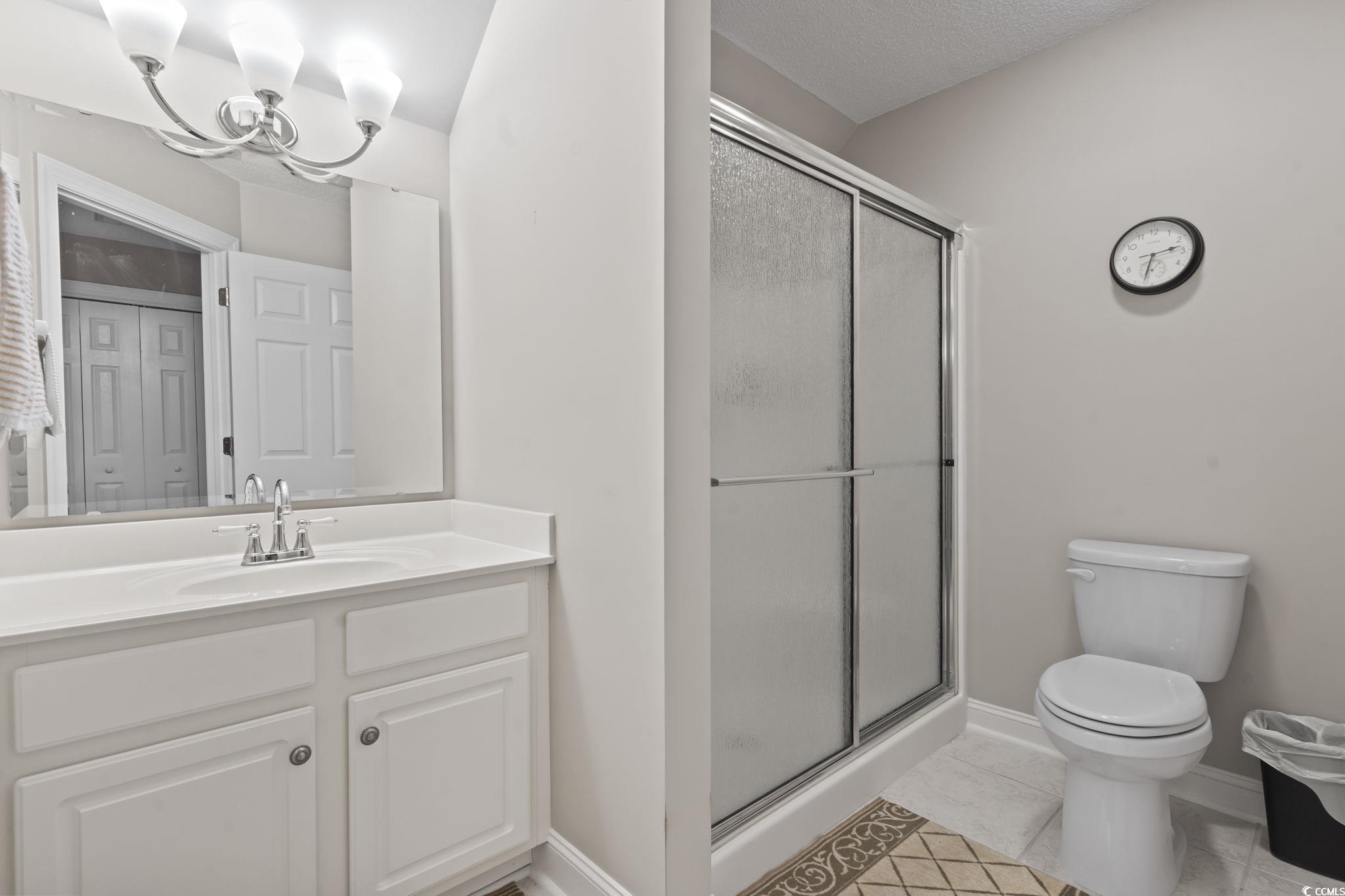 4495 Trotters Court Murrells Inlet, SC 29576 - Photo 15 of 29 Full bathroom with vanity, a shower stall, and tile patterned floors