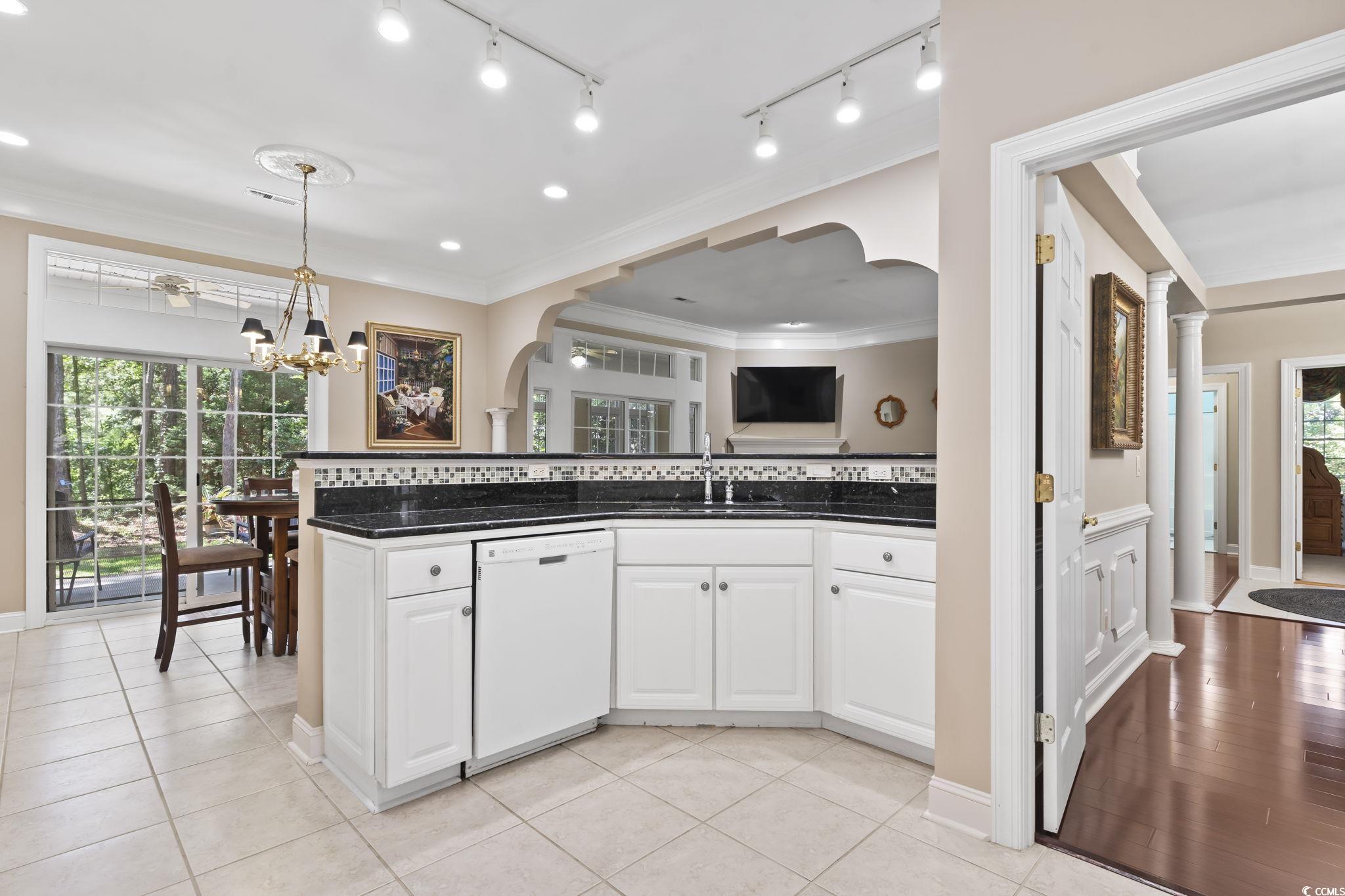 4495 Trotters Court Murrells Inlet, SC 29576 - Photo 26 of 29 Kitchen featuring dishwasher, arched walkways, healthy amount of natural light, white cabinets, and ornamental molding