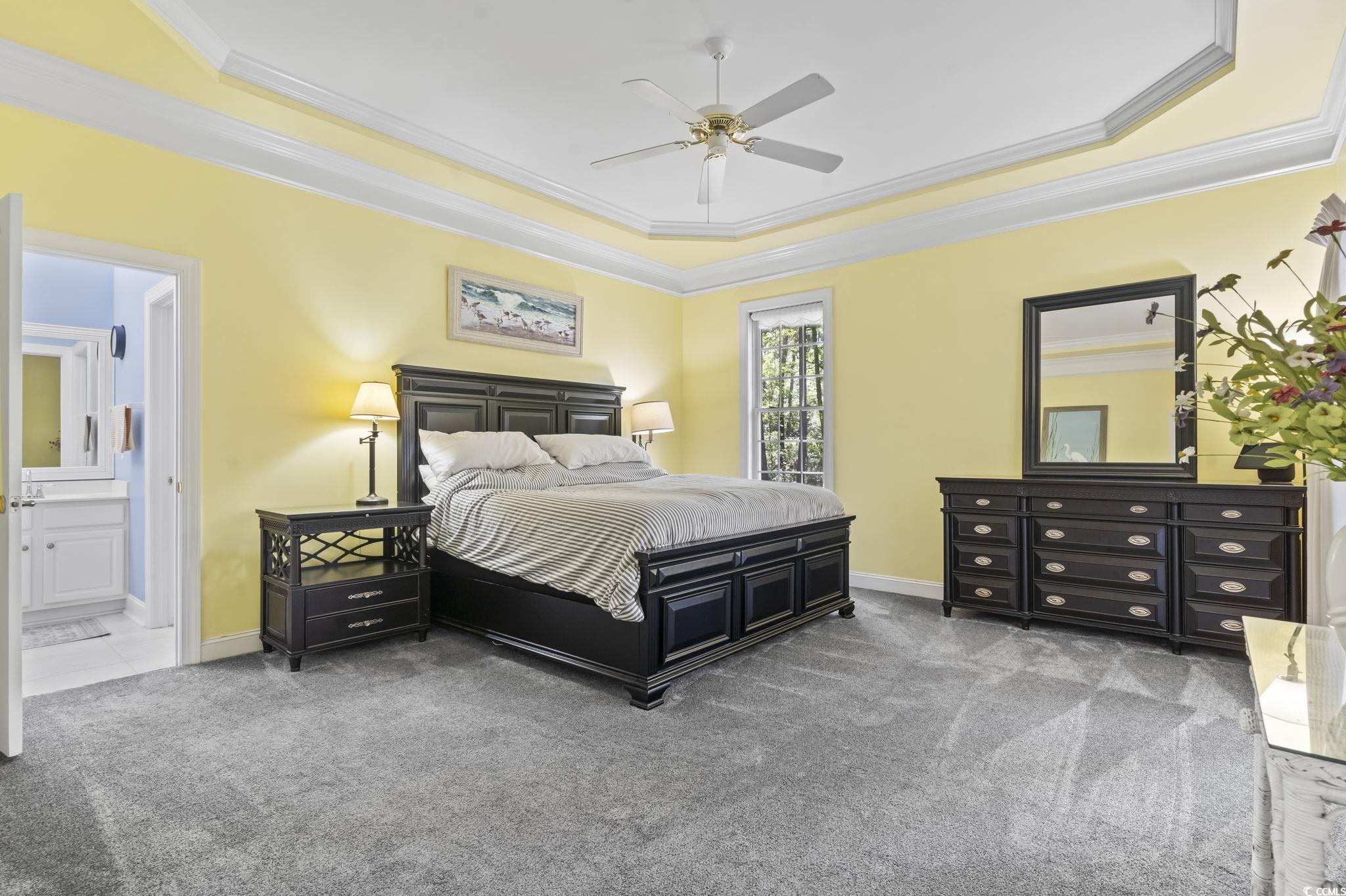 4495 Trotters Court Murrells Inlet, SC 29576 - Photo 10 of 29 Bedroom featuring a tray ceiling, crown molding, carpet floors, ensuite bathroom, and a ceiling fan