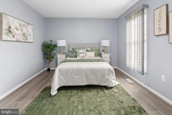 a bedroom with a bed and a potted plant