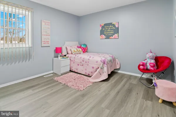 a bedroom with a bed dresser and a window