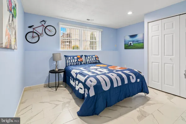 a bedroom with a bed and painting on the wall