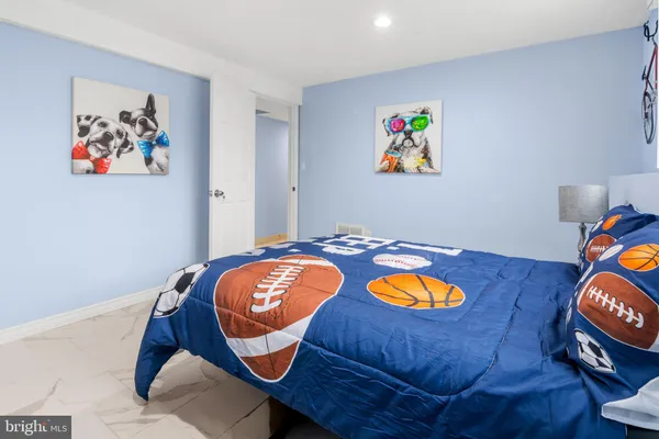 a bed room with a bed and painting on the wall