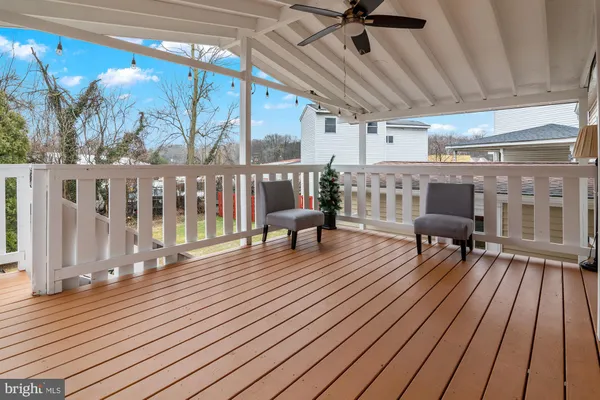 a view of a balcony with furniture and wooden floor