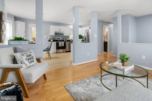a living room with furniture and kitchen view