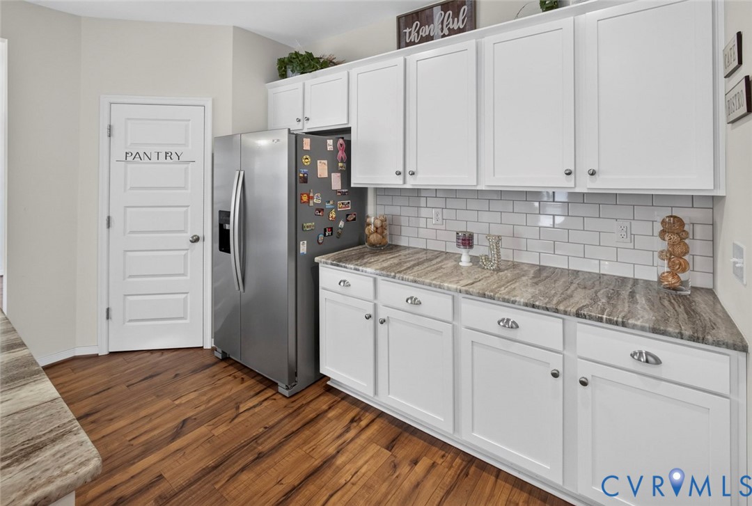 7507 Rouseaux Circle Chesterfield, VA 23832 - Photo 13 of 37 Wood-finish flooring with white cabinetry, stainle
