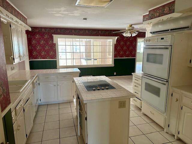 4503 14th Street Lubbock, TX 79416 - Photo 7 of 17 a kitchen that has a sink and a stove in it
