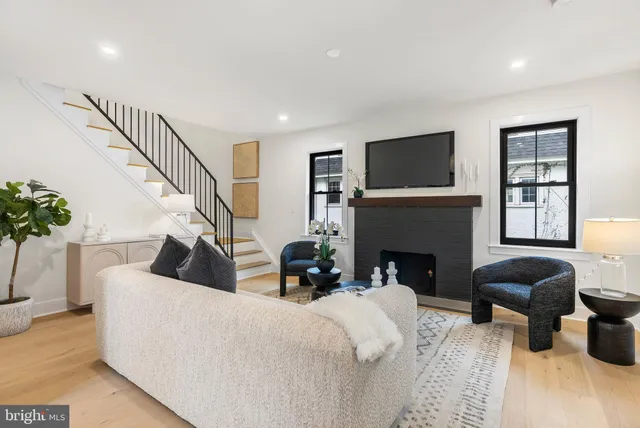 a living room with furniture a fireplace and a flat screen tv