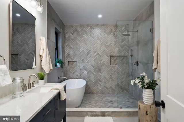 a bathroom with a granite countertop sink a toilet and shower