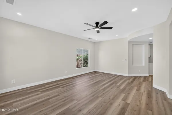 a view of a room with wooden floor and white walls