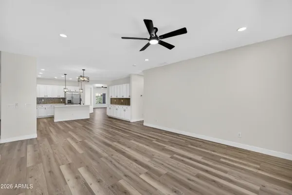 a large white kitchen with a refrigerator a stove a sink and white cabinets