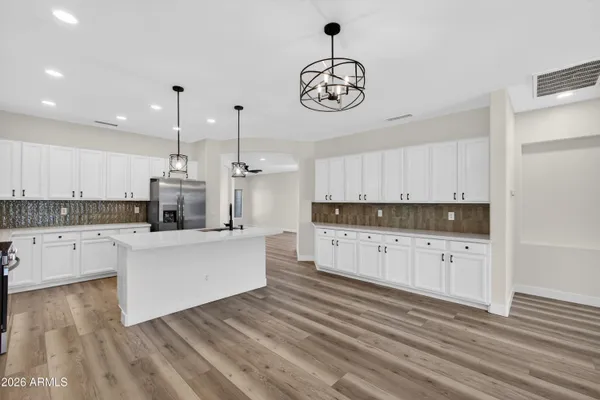 a kitchen with stainless steel appliances a stove a microwave and cabinets