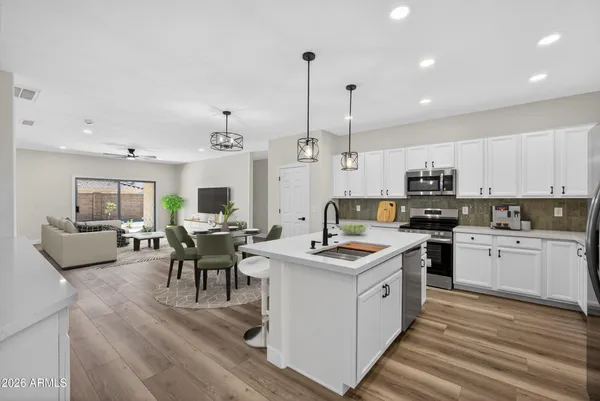 a view of a kitchen counter space a sink wooden floor and a window