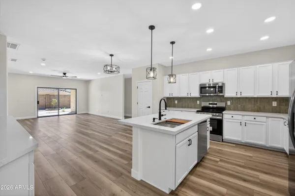 a kitchen with a refrigerator and cabinets