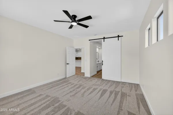 a view of a walk in closet and wooden floor