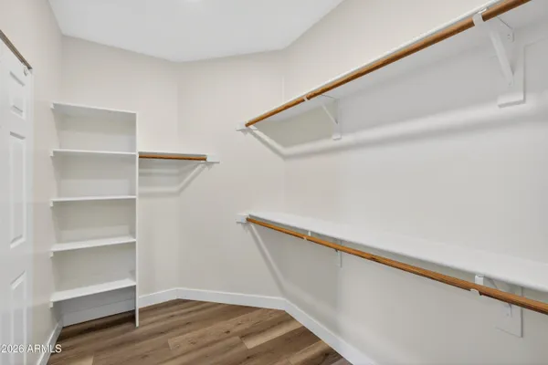 an empty room with a window and a ceiling fan