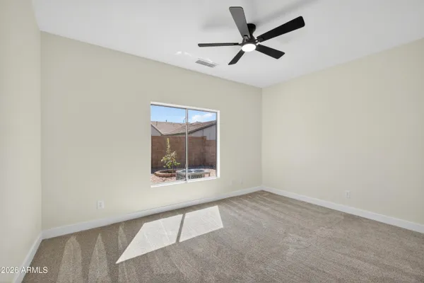 an empty room with ceiling fan