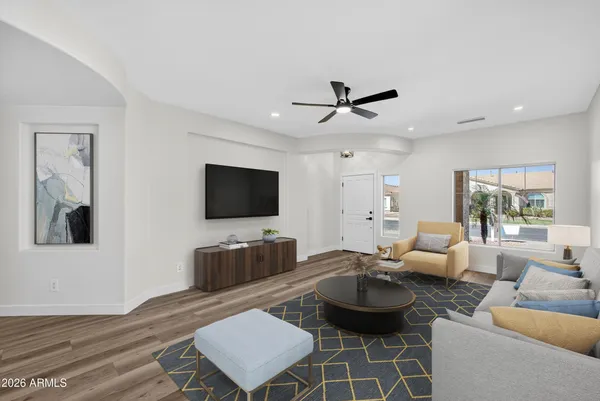 a view of empty room with wooden floor and ceiling fan