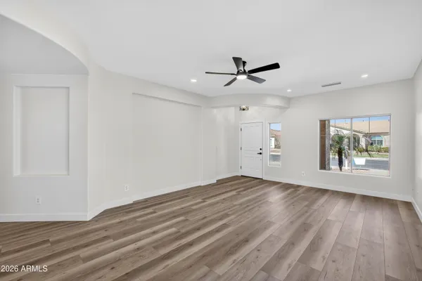 wooden floor in an empty room with a window