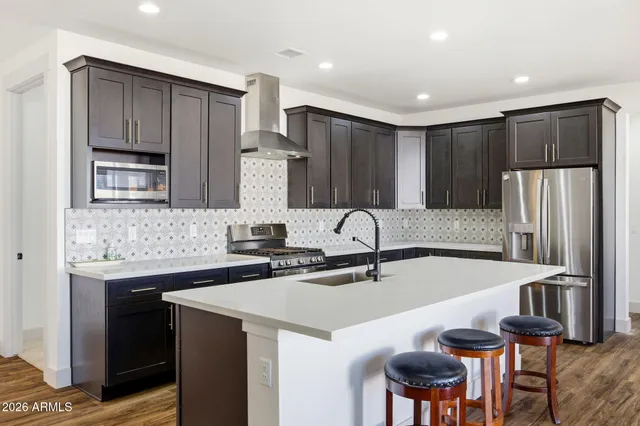 a kitchen with stainless steel appliances a sink and a refrigerator