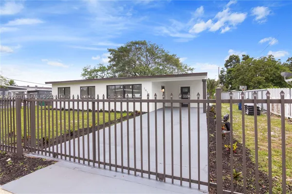 a view of a house with a wooden deck
