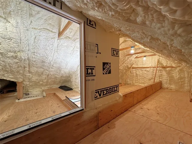 a view of storage and utility room with window