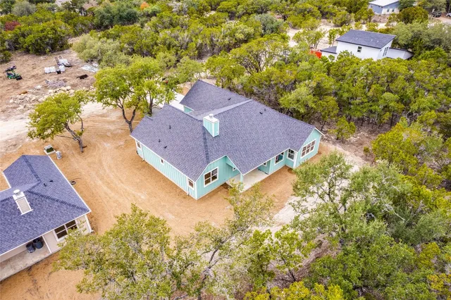 a aerial view of a house with a yard and garden