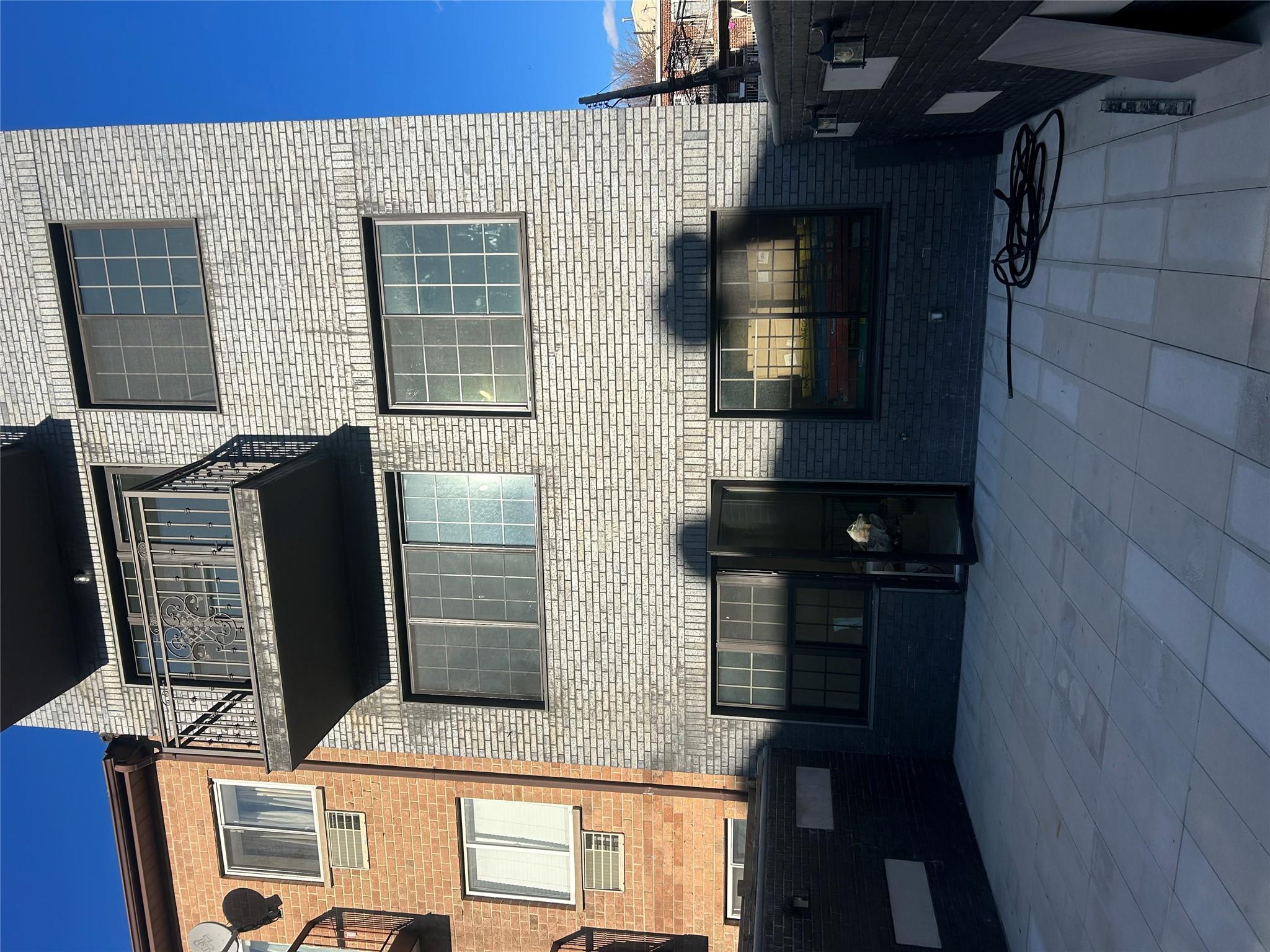 55-12 102nd Street Queens, NY 11368 - Photo 7 of 9 a front view of a house with barbeque